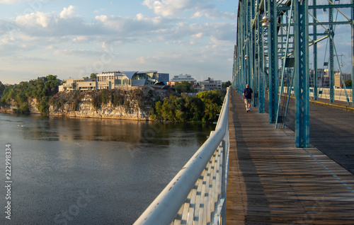 Man walking on bridge toward landmark in Chattanooga, Tennessee,