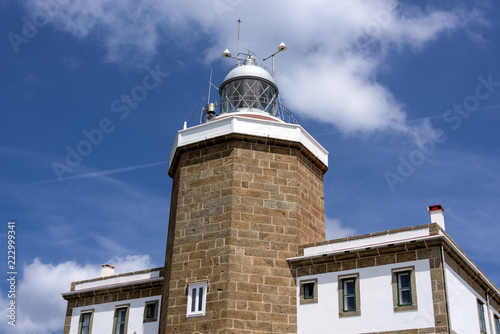 Wallpaper Mural Spain, Finisterre: Lighthouse with and blue sky - concept nautical maritime danger navigation hazard travel traffic. The building is located on Spanish coast which was known at the end of the world. Torontodigital.ca