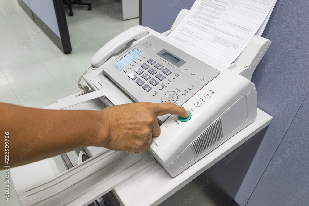 Finger pressing start button on the fax, business concept. Finger pressing start button on the fax, business concept.