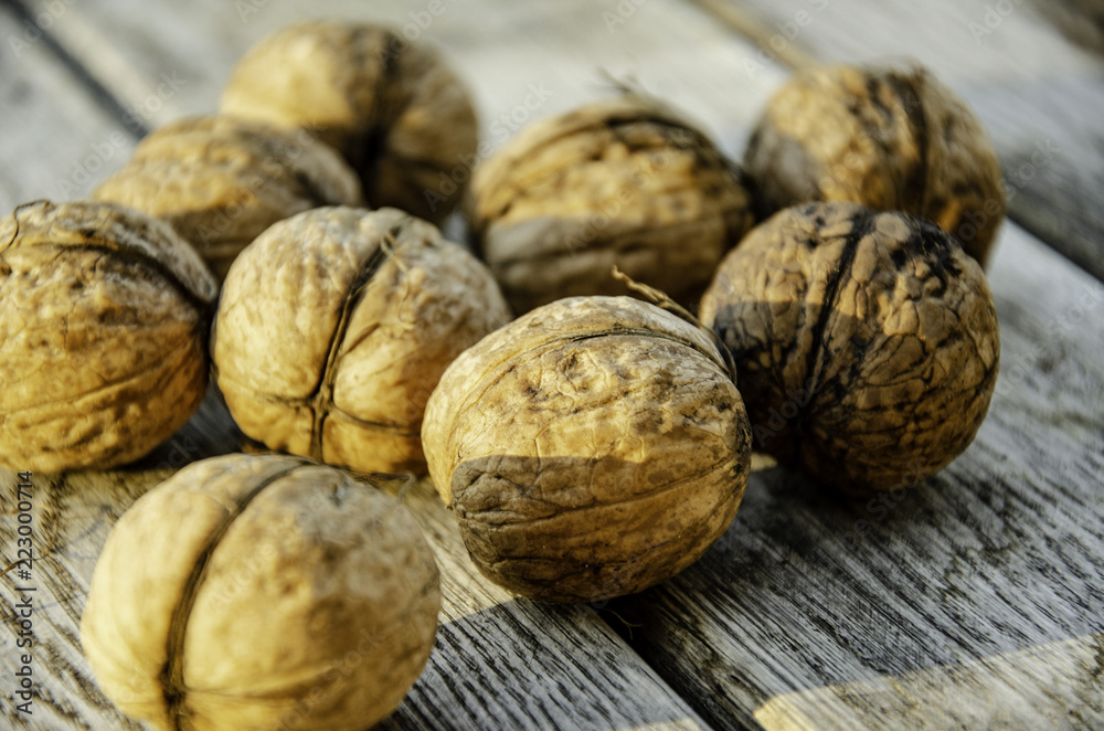 Harvest of a walnut in a garden on a wooden background. Harvest of a walnut in a garden on a wooden background.