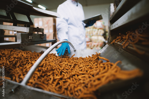 Closeup of salty snacks in factory production line.
