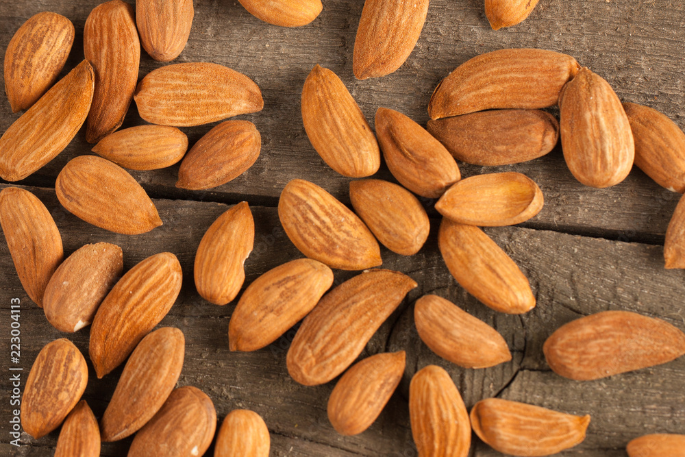 Fototapeta premium Almonds on wooden background