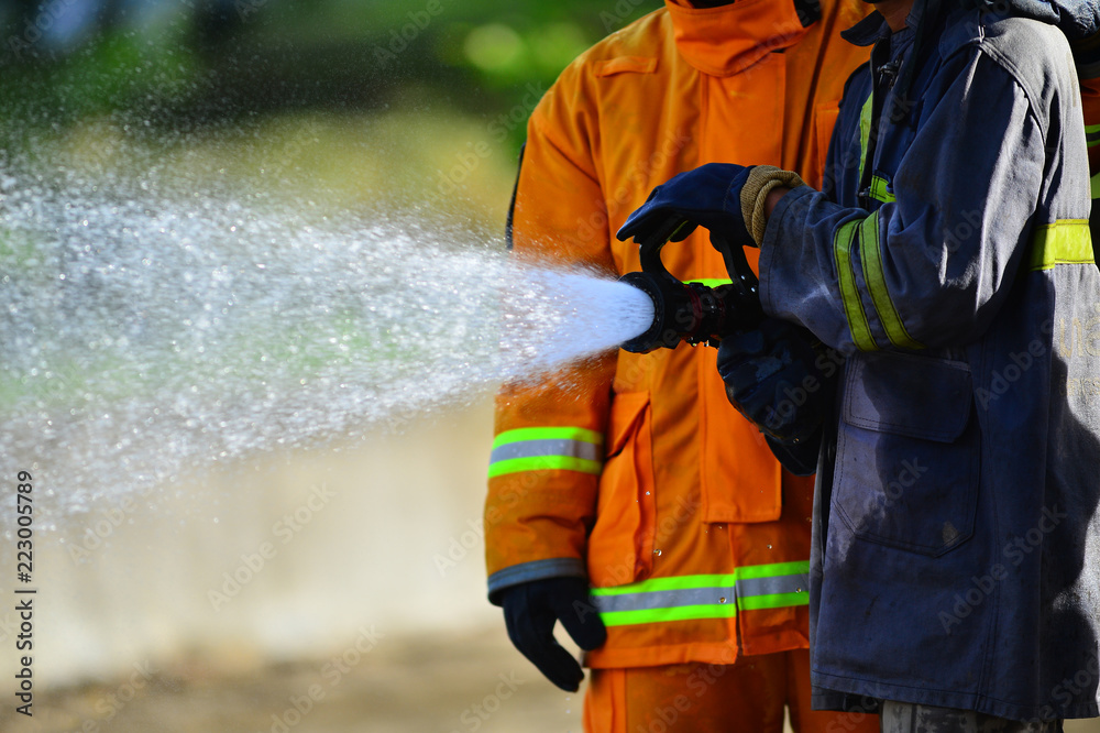 firefighters training with fire hose
