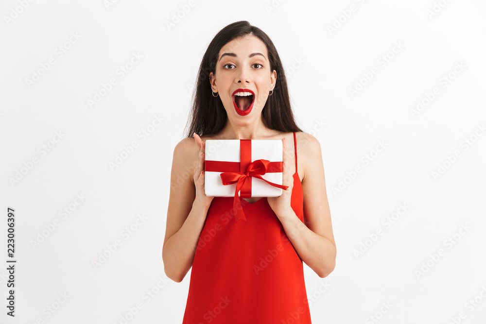 Fototapeta premium Excited woman posing isolated holding gift box surprise.