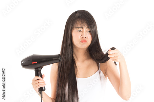 woman holding hair dryer and looking damaged hair she so serious and worries,Isolated on white background,Haircare Concept