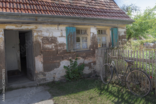 Abandoned old house with bike and garden