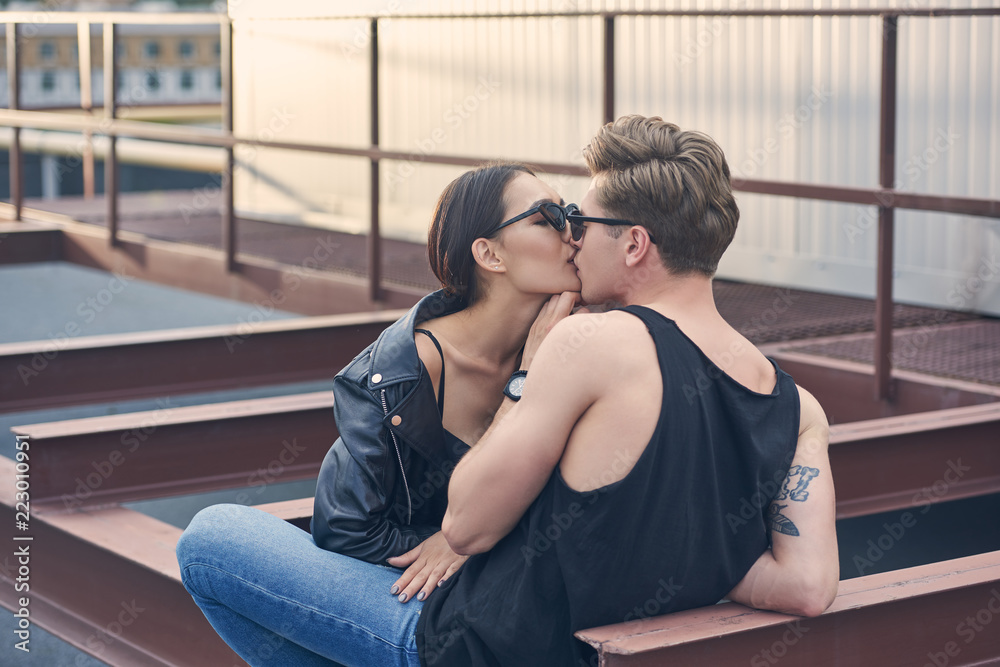 interracial stylish hot couple kissing on urban roof foto de Stock | Adobe  Stock