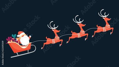 Santa Claus flying in sleigh with gifts photo