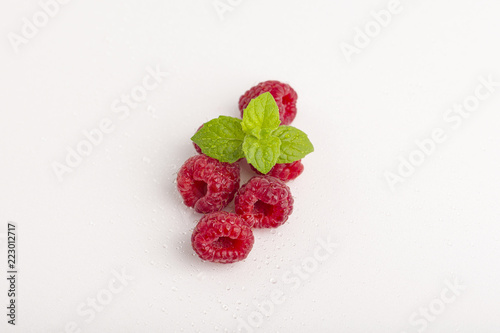 Sweet raspberry with mint isolated on white background
