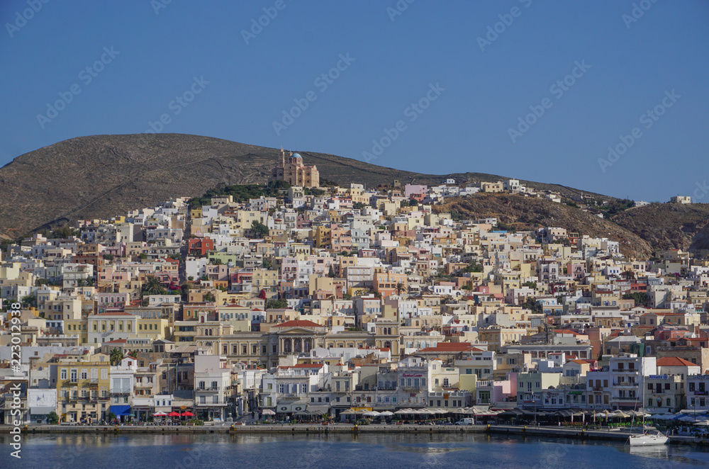 Hermoupolis, Syros, Greece: Saint Nicholas Church on the hill overlooking houses, shops, and the harbor at Hermoupolis on the Aegean island of Syros.
