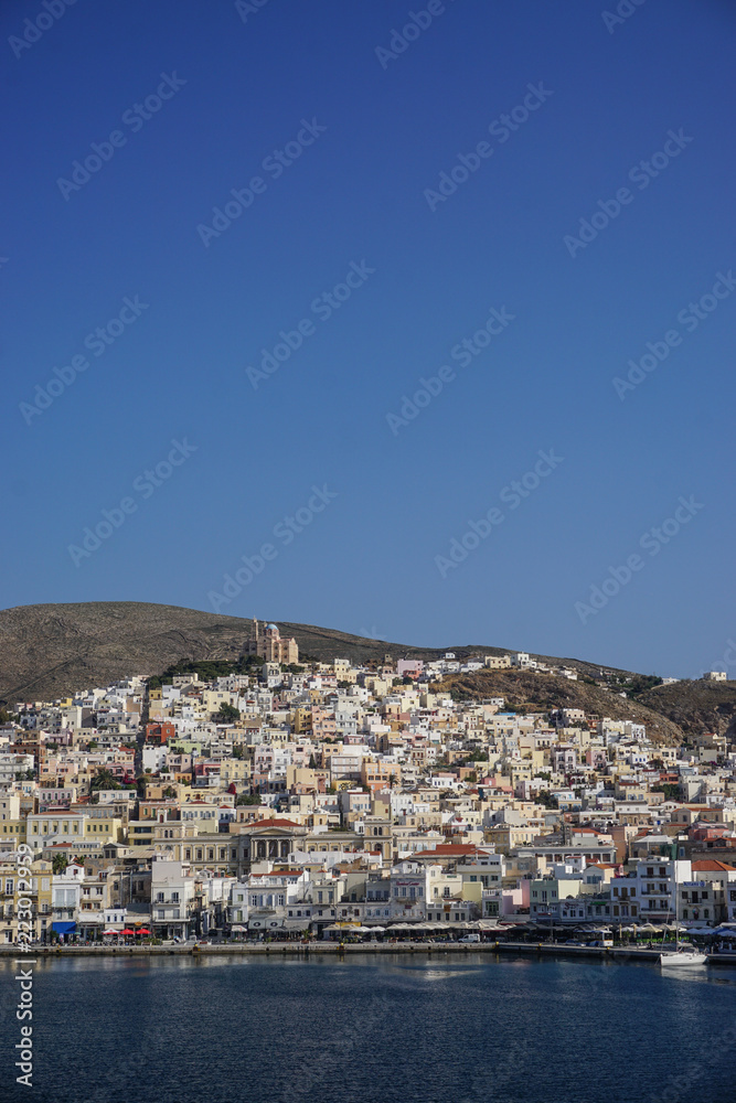 Hermoupolis, Syros, Greece: Saint Nicholas Church on the hill overlooking houses, shops, and the harbor at Hermoupolis on the Aegean island of Syros.