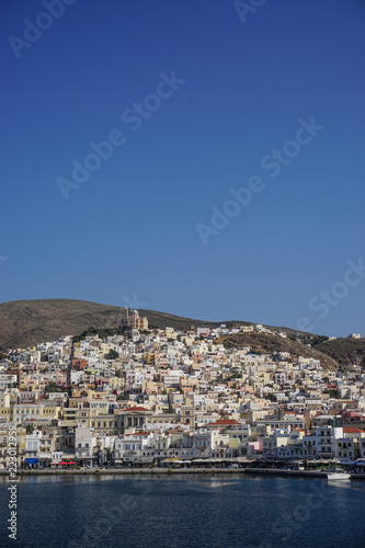 Hermoupolis, Syros, Greece: Saint Nicholas Church on the hill overlooking houses, shops, and the harbor at Hermoupolis on the Aegean island of Syros. © Linda Harms