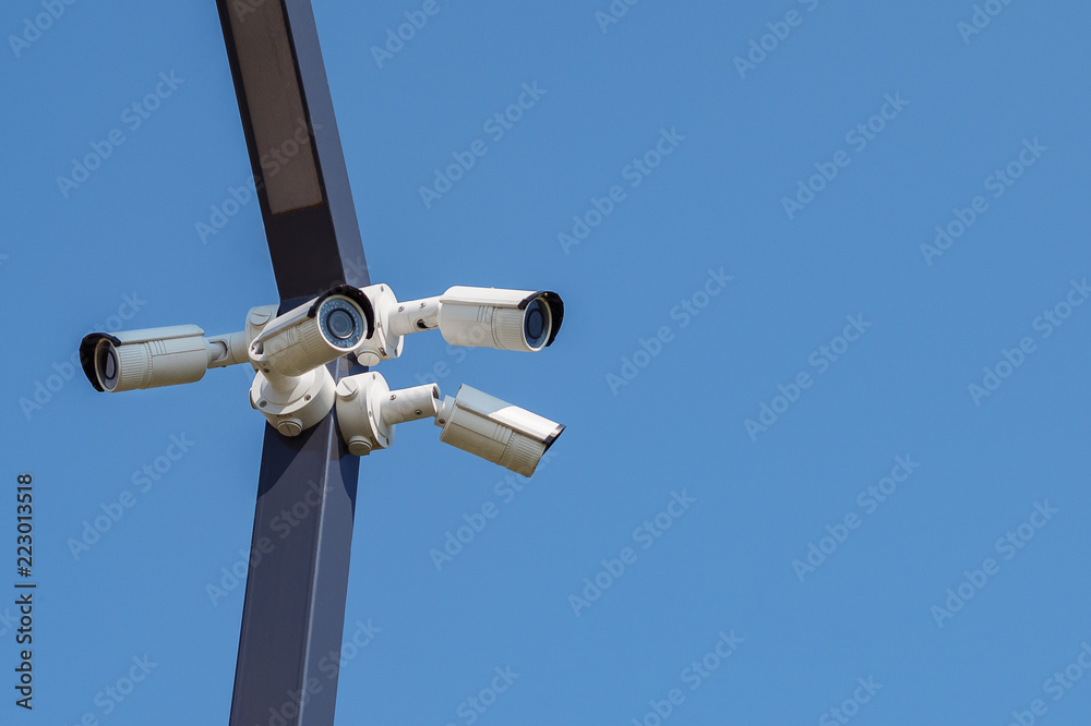 Multi-angle CCTV surveillance security camera video equipment on the blue sky background Multi-angle CCTV surveillance security camera video equipment on the blue sky background
