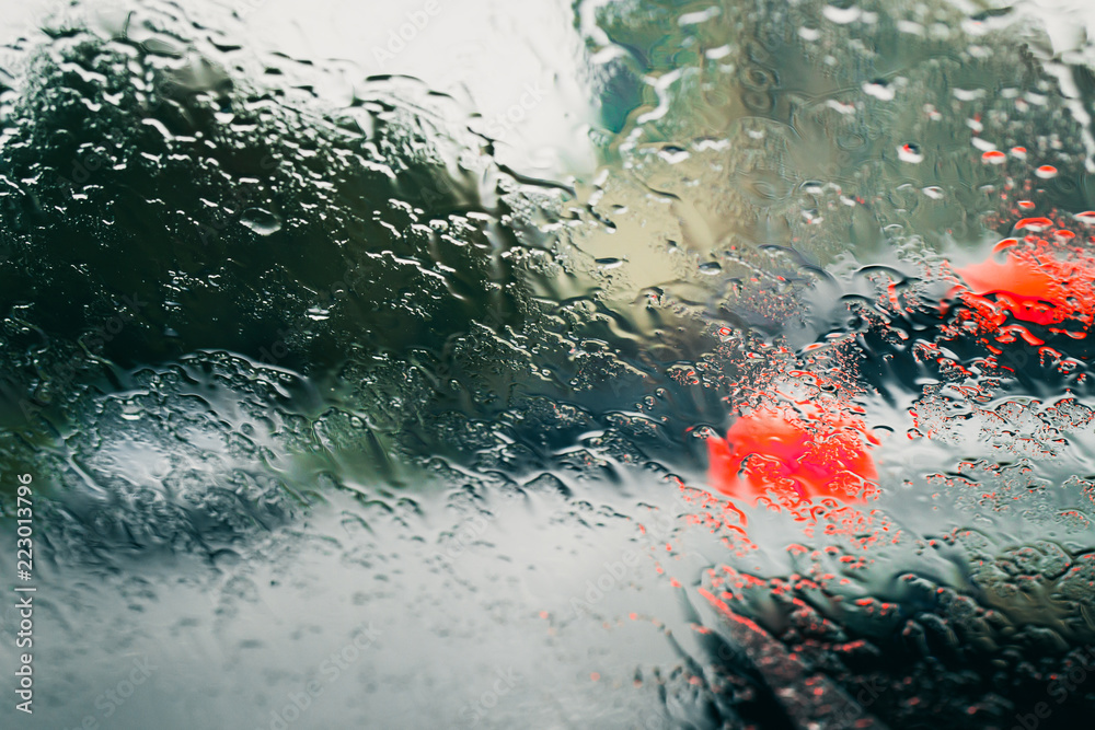 City road seen through rain drops on the car windshield City road seen through rain drops on the car windshield