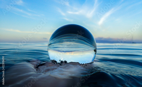 Ocean Surface Ripples and Clouds in Sky Captured in Glass Ball