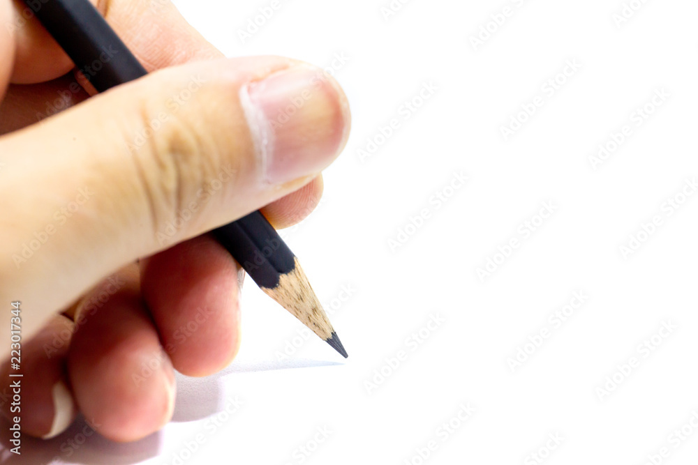 Holding a pencil ready to writing on a white paper Holding a pencil ready to writing on a white paper
