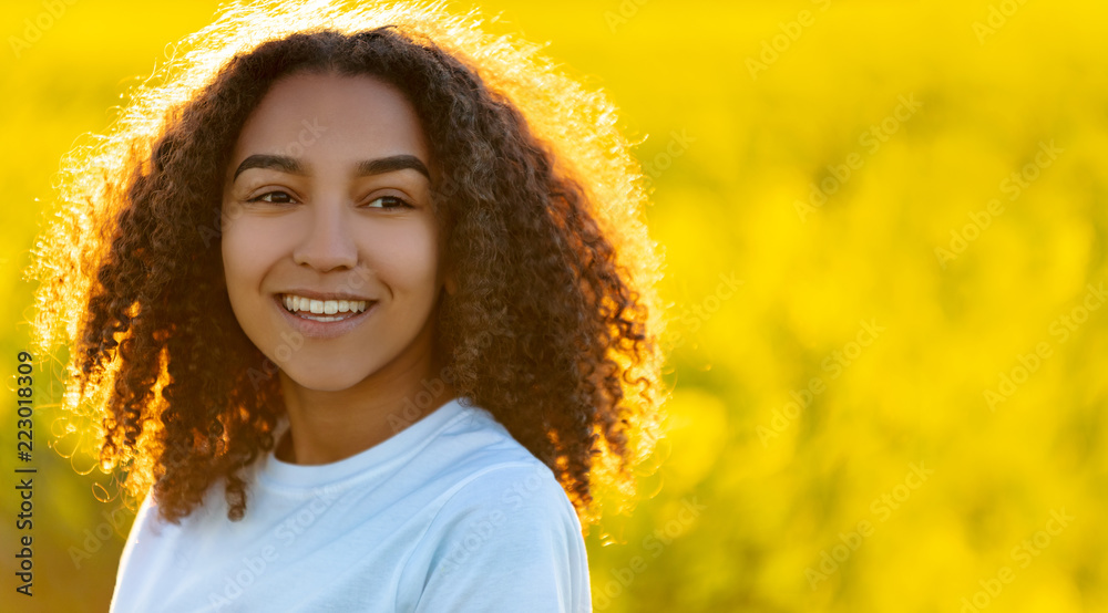 Happy Mixed Race African American Teenager Woman in Yellow Flowers Happy Mixed Race African American Teenager Woman in Yellow Flowers