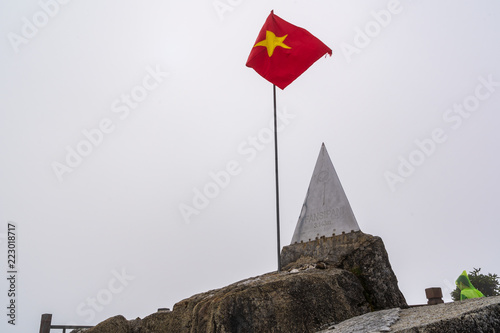 Peak of Fansipan and flag in the clouds on SAPA VIETNAM. Top spot in Indochina altitude 3,143m landmark in VIETNAM photo