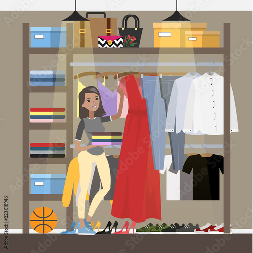 Smiling woman choosing clothes in the wardrobe
