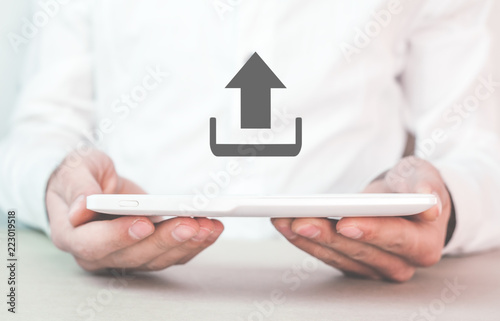 Obraz na płótnie Man holding tablet with web upload icon.