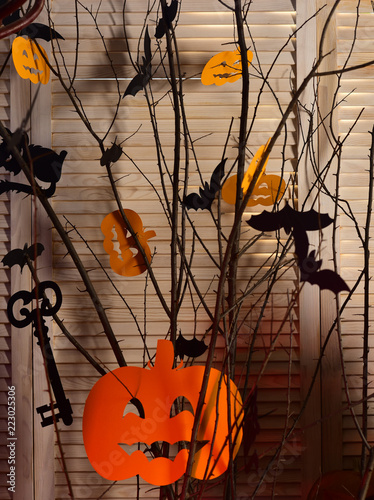 Halloween party decorations. Halloween symbols hang on tree. Caution  low flying bats. Happy spooky halloween. Please come in for a bite