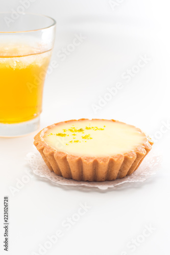 One single lemon tart, isolated on white.