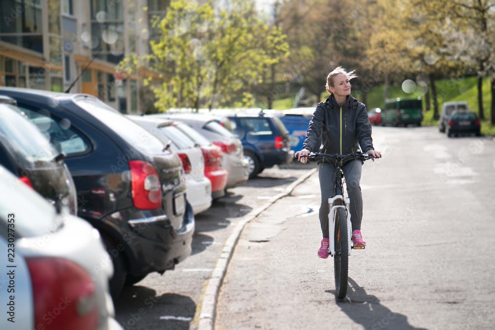 woman commuting on bicycle and looking at camera