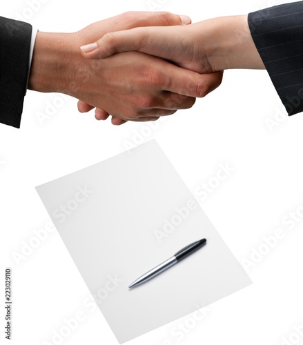 Closeup of Business People Shaking Hands with Contract on