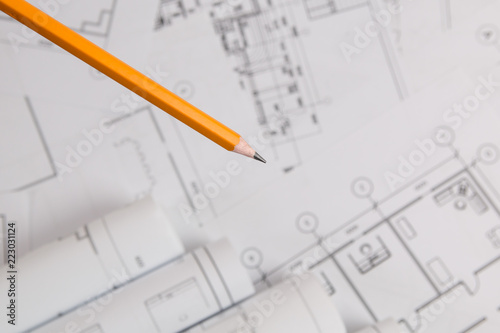 yellow pencil on architectural blueprint background