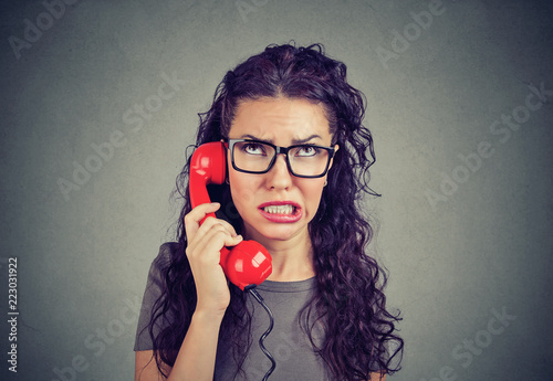 Worried woman receiving bad news on phone