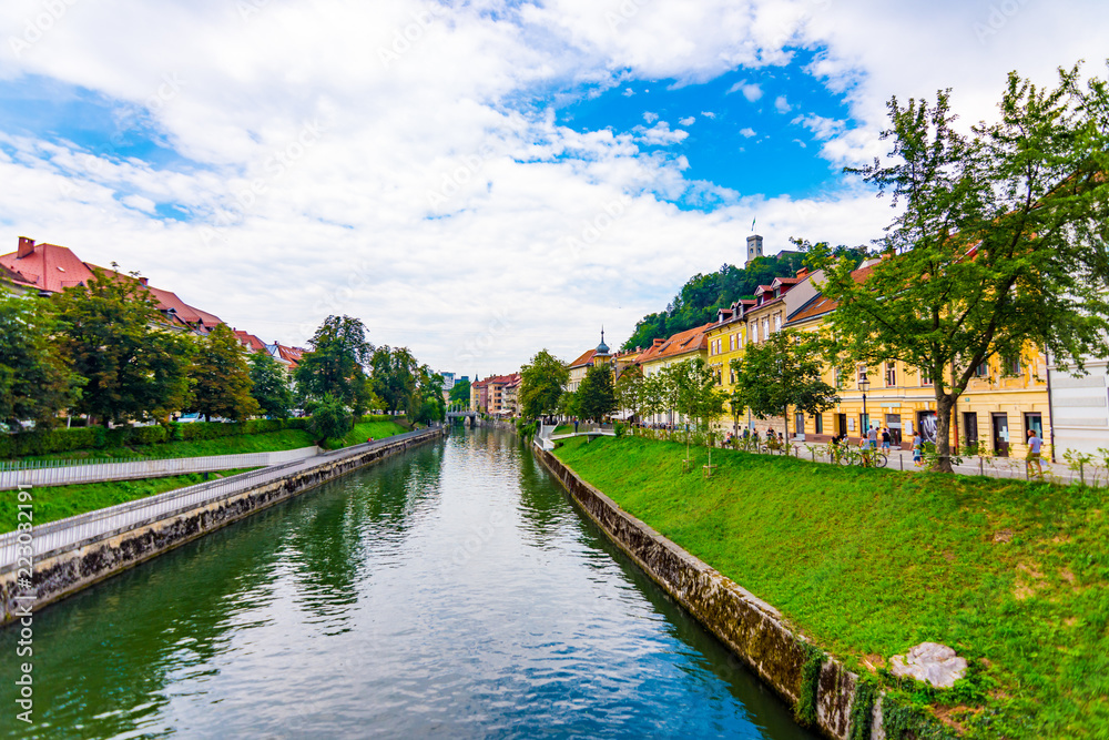 Ljubljana old town center, view of Ljubljanica river in city center. Old building historic panorama. Look to old bridge with tourist.