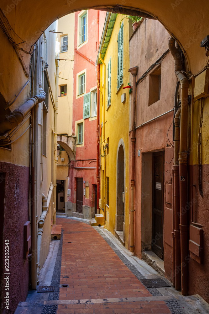 Fototapeta premium Path between colored houses in Menton, France