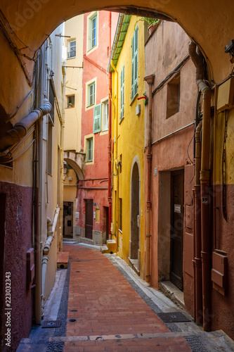 Path between colored houses in Menton, France