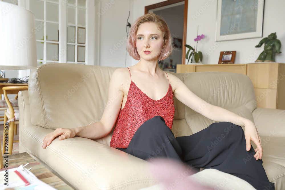young beautiful lady on the leather sofa young beautiful lady on the leather sofa