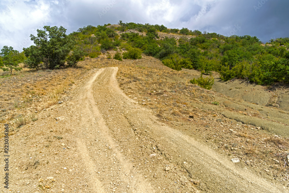 Steep descent on a dirt road.
