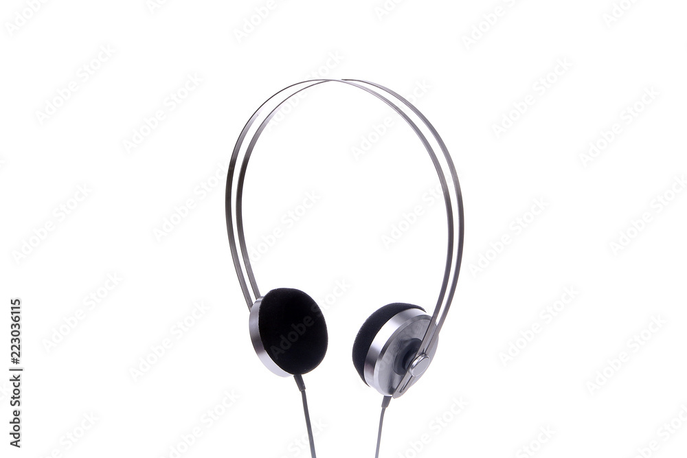 Silver headphones with cable isolated on white background. Silver headphones with cable isolated on white background.