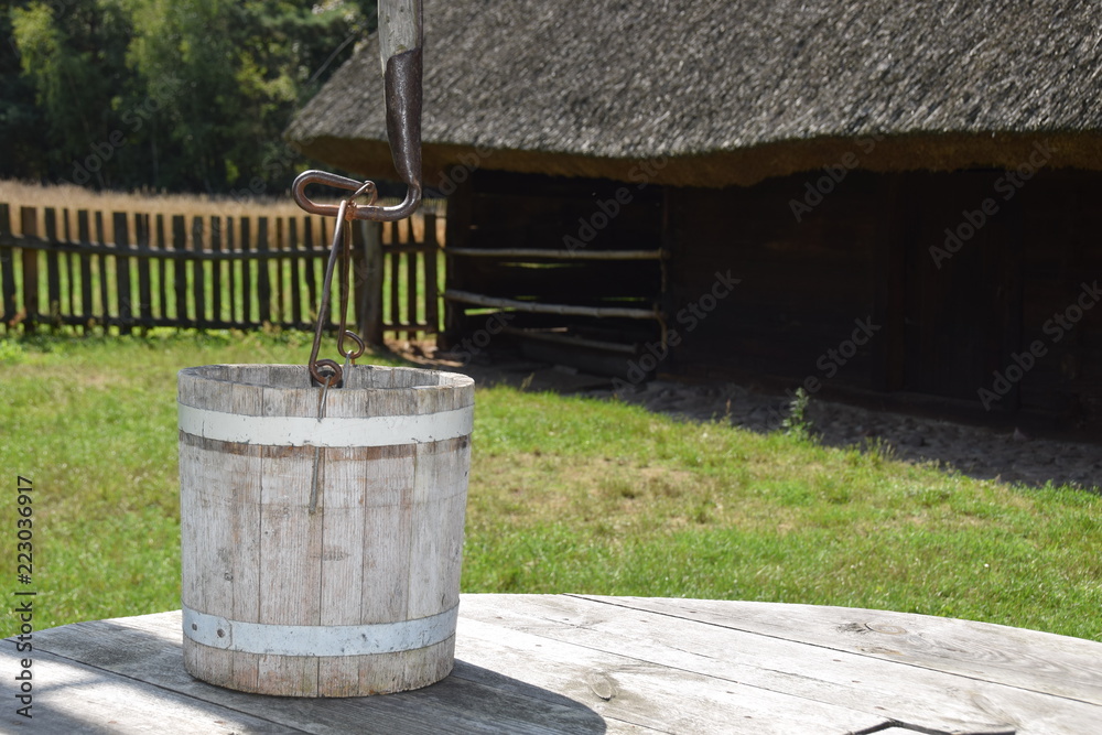 Naklejka premium an old bucket for getting water from a deep well
