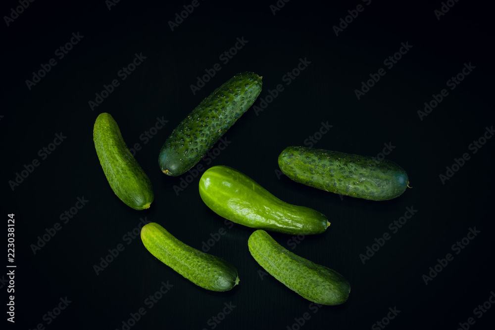 Cucumbers on black wood