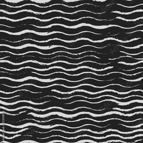 Black chalk board. White waves are written on the board. Seamless pattern.