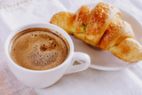 A delicious morning  frothy coffee  and croissants