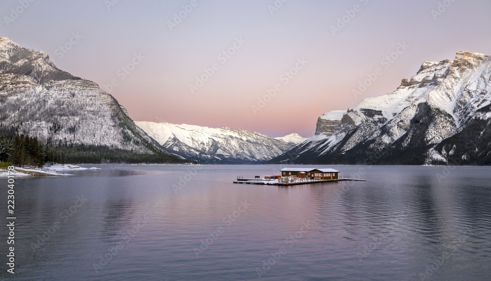 Dramatic Sunset Sky and Distant Snowcapped Rocky Mountains at Lake Minnewanka in Banff National Park, Alberta, Canada