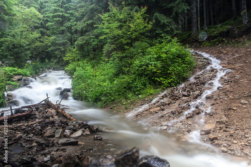 Fast and rapid mountain stream current after rain
