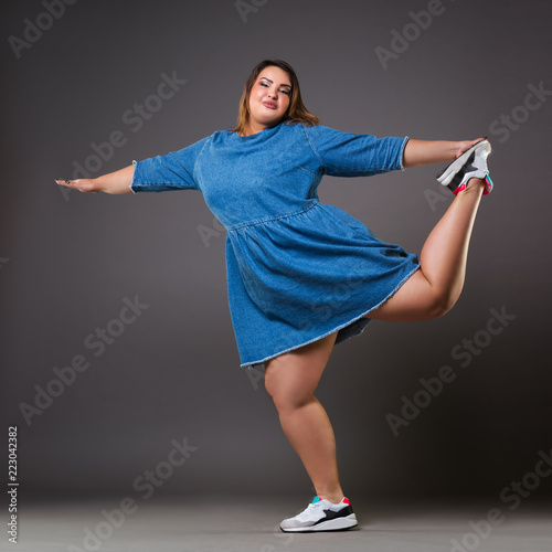 Konstfotografi Plus size model in denim dress, fat woman on gray background, overweight female