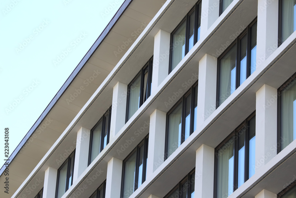 The facade of the building with Windows on the background of blue sky The facade of the building with Windows on the background of blue sky