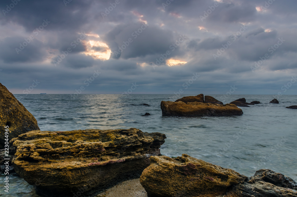 Sunset on the sea beach with stones Sunset on the sea beach with stones