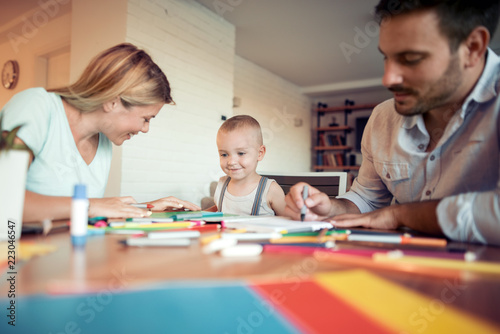 Young parents with child drawing