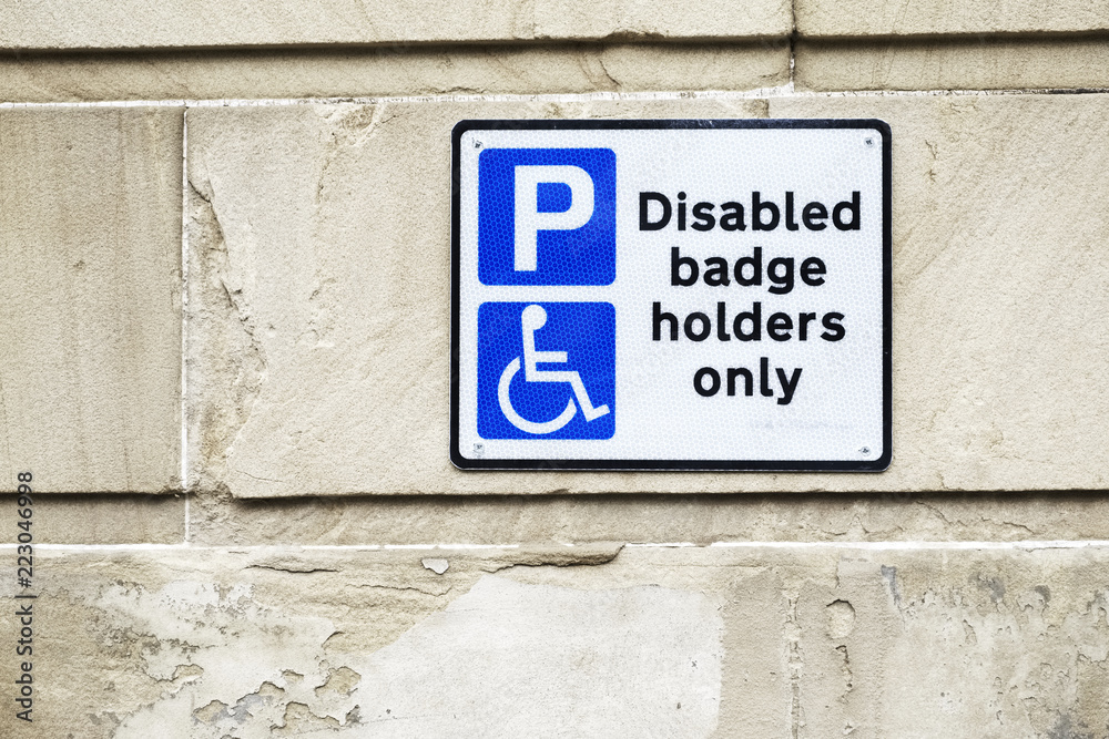 Fototapeta Disabled Badge Holders Only at Car Park Sign on Wall