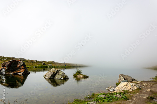 Fog rolling in at lake Stellisee with a view of the Matterhorn