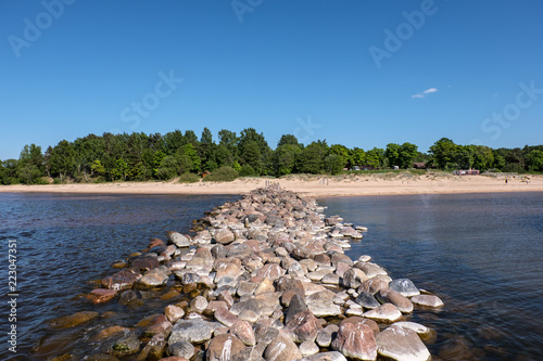 old stone brakewater in the Baltic sea photo
