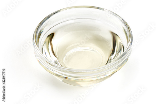 White Vinegar in a glass bowl, isolated on white background. Top view.